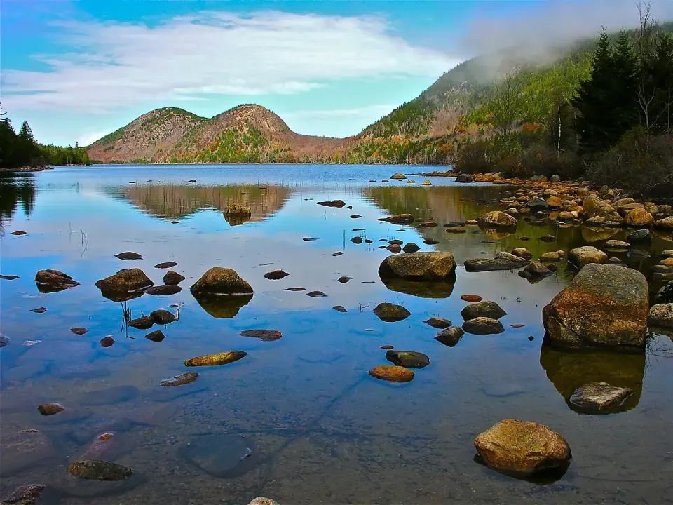 Coastline at dusk, evoking Acadia's mix of forest and Atlantic.