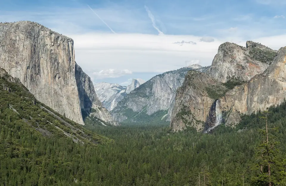 Yosemite Valley with granite walls and pine forest.